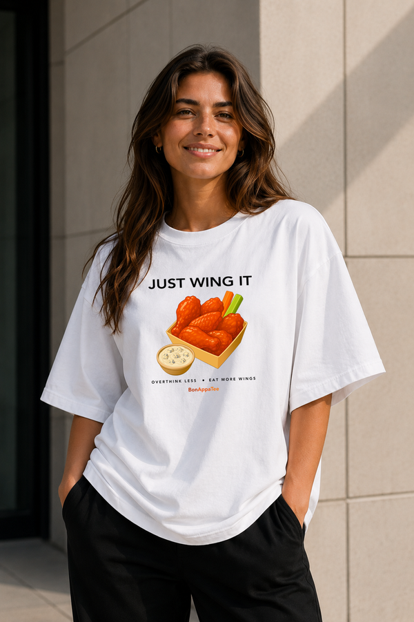 Female wearing Just Wing It Tee — chicken wing graphic on premium oversized white T-shirt by BonAppaTee