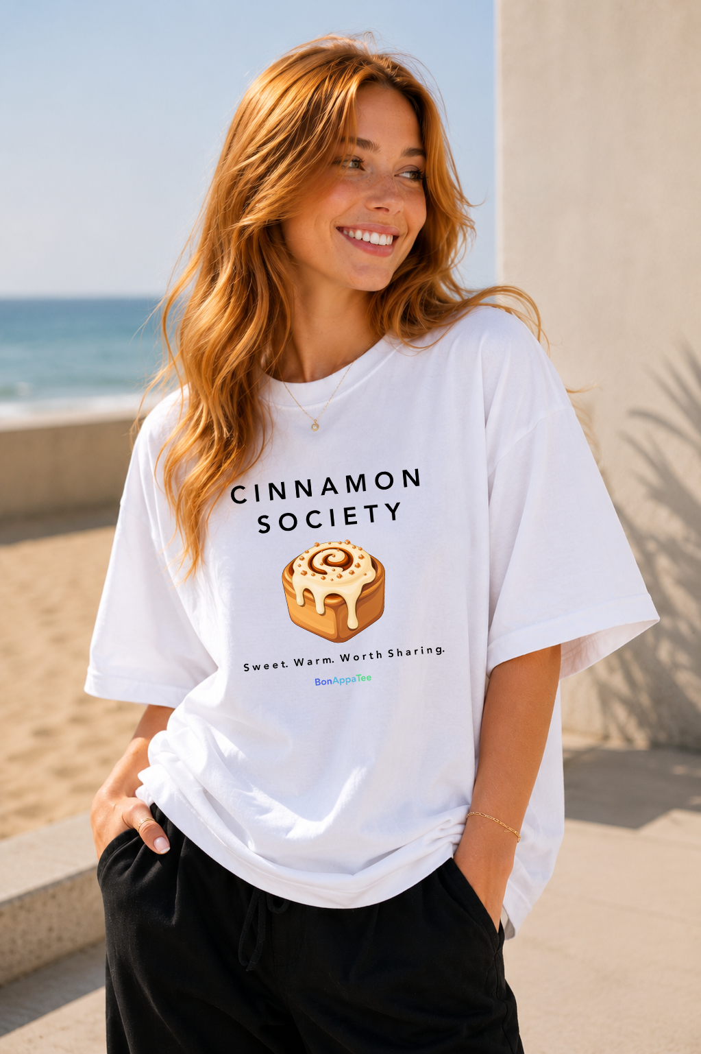 Female wearing Cinnamon Society Tee — cinnamon bun graphic on premium oversized white T-shirt by BonAppaTee