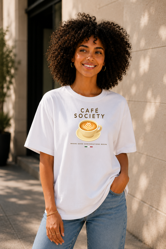 Female wearing Café Conversations — cappuccino graphic on premium oversized white T-shirt by BonAppaTee
