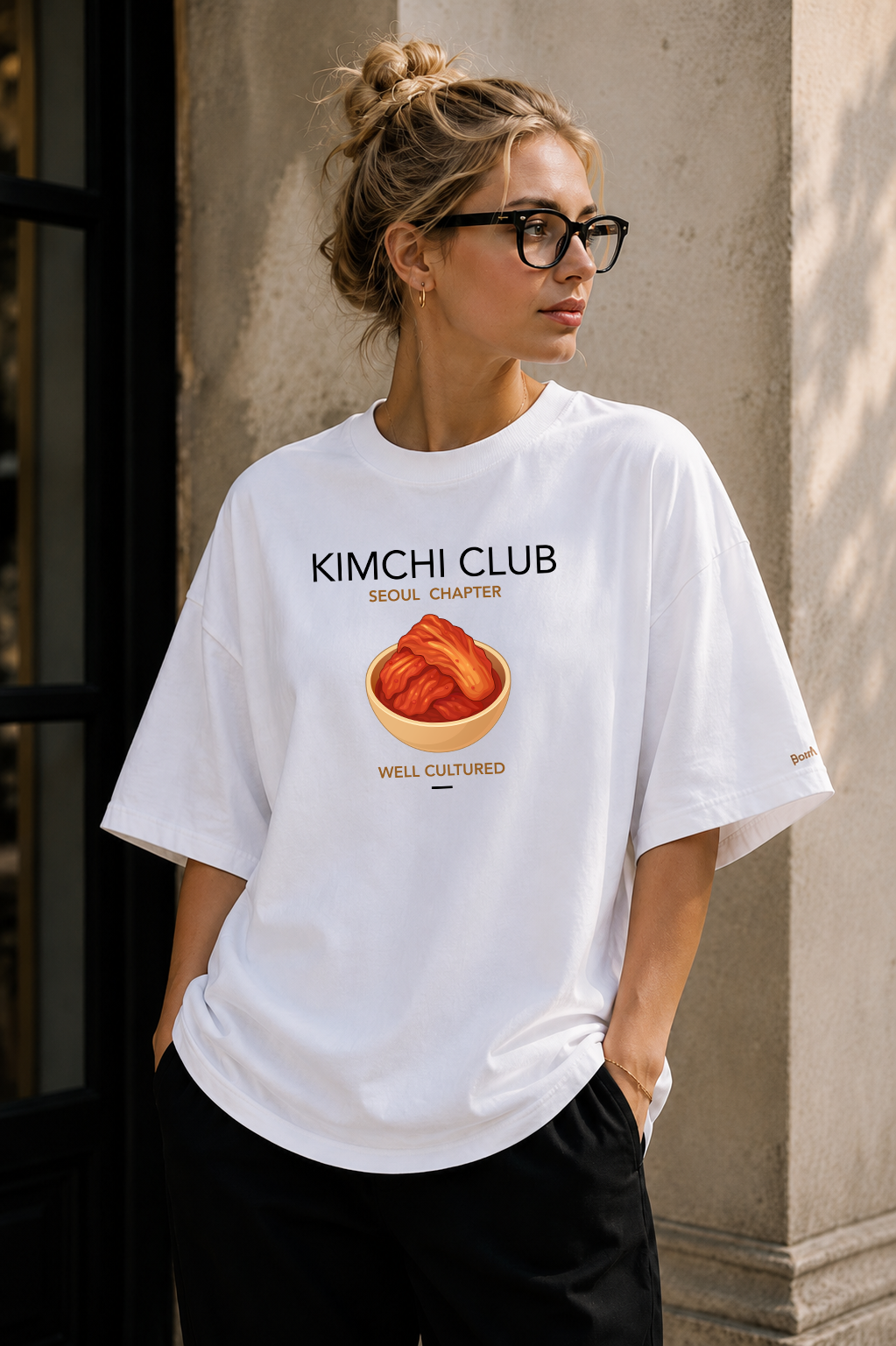 Female wearing Kimchi Club Seoul Chapter — Korean food graphic on premium oversized white T-shirt by BonAppaTee