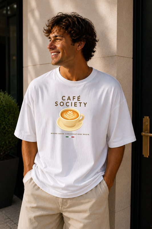 Male wearing Café Conversations — cappuccino graphic on premium oversized white T-shirt by BonAppaTee
