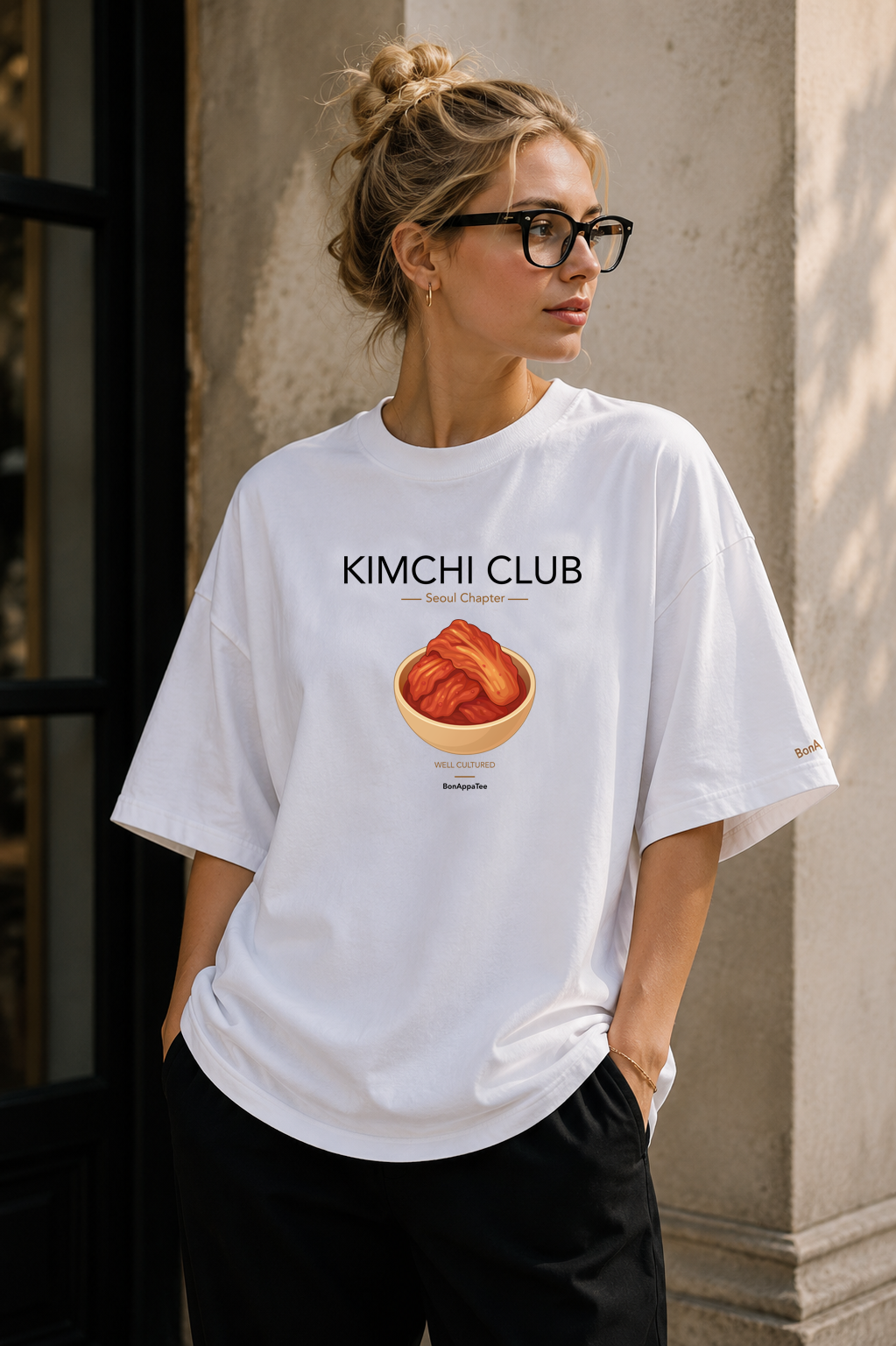 Female wearing Kimchi Club Seoul Chapter Tee — Korean food graphic on premium oversized white T-shirt by BonAppaTee