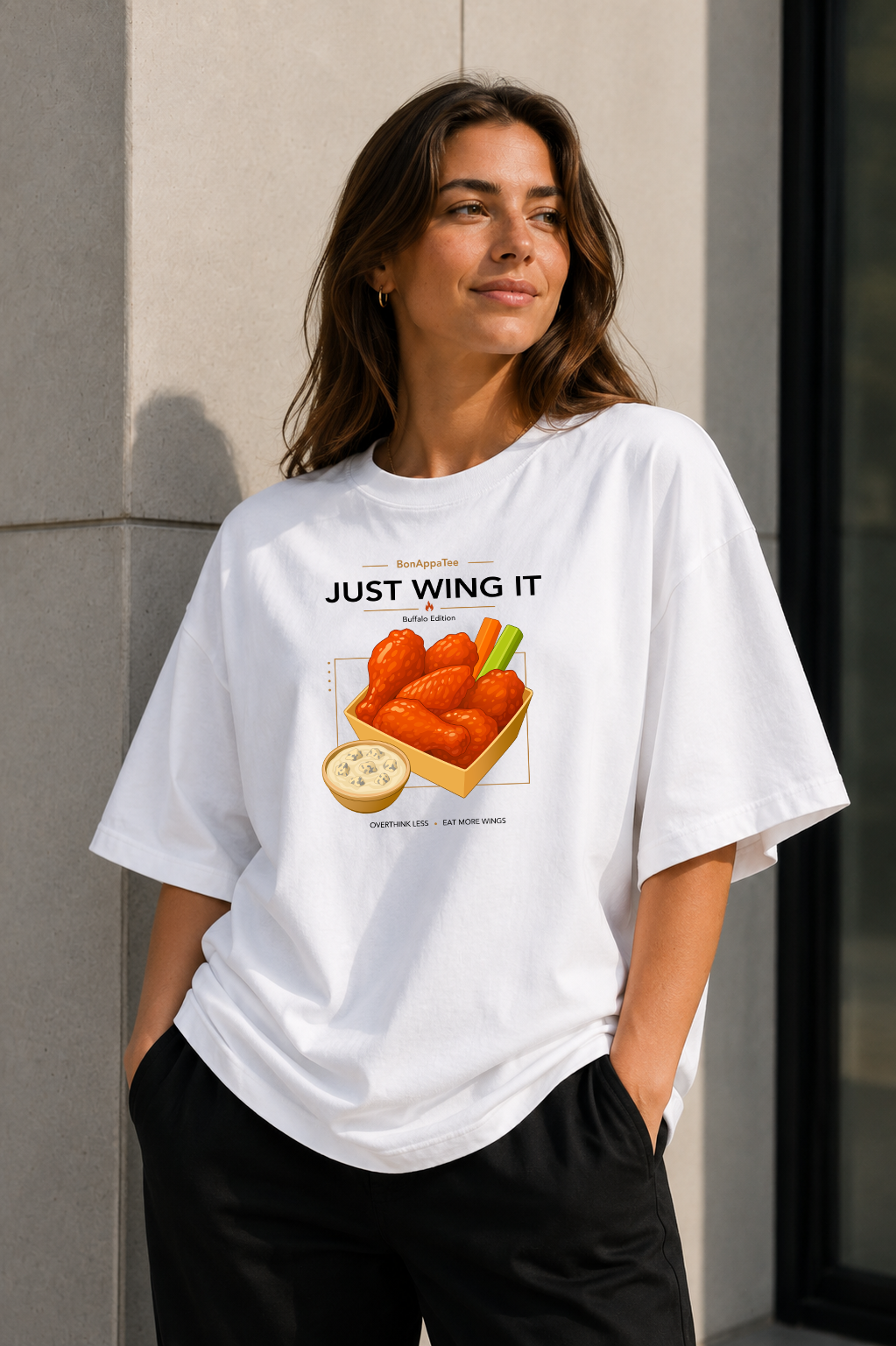 Female wearing Just Wing It Tee — chicken wings graphic on premium oversized white T-shirt by BonAppaTee